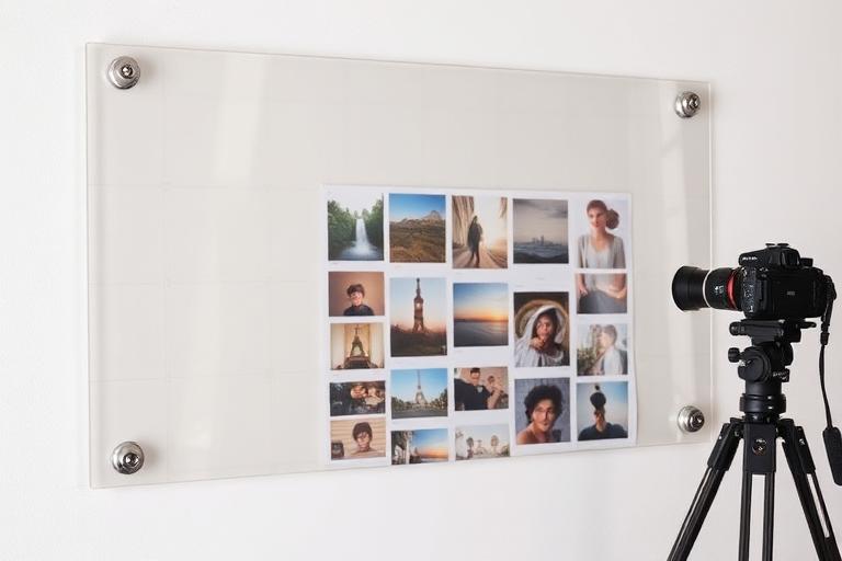 Transparent DayByLife wall planner used as a content schedule — the clear grid shows the wall behind it